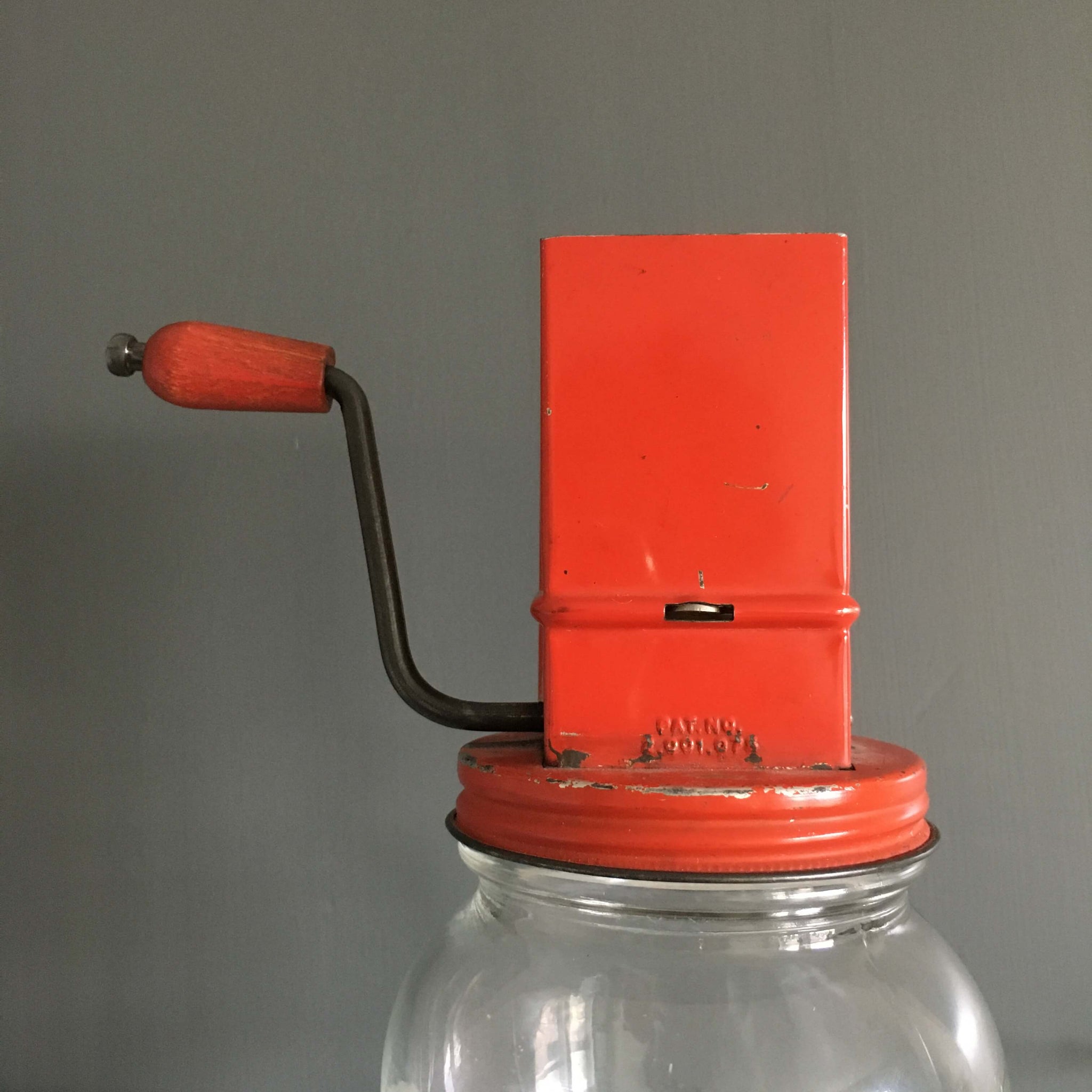 1930s vintage nut grinder, old red paint metal hand crank nut crusher w/  glass jar