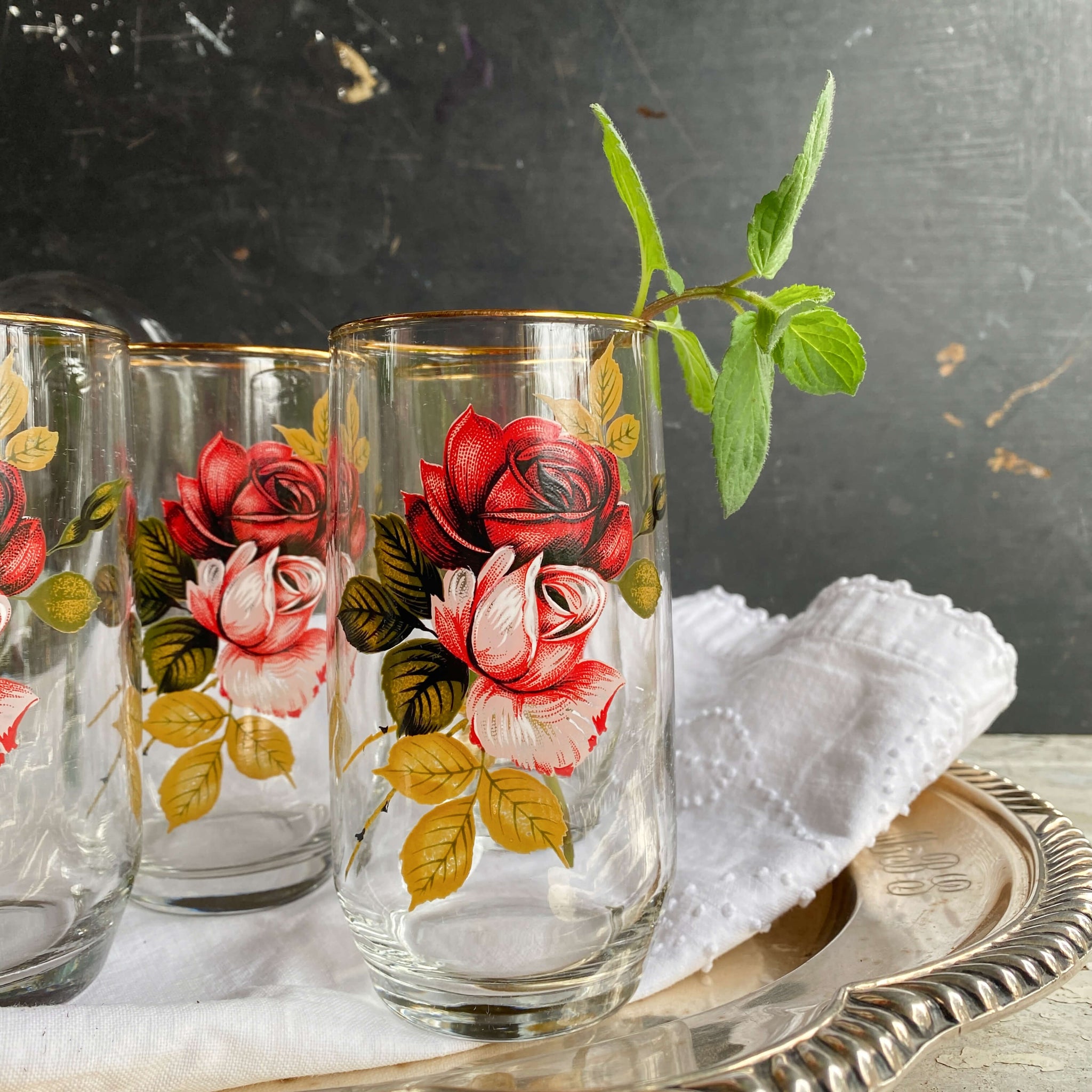 https://shopinthevintagekitchen.com/cdn/shop/products/vintage-barware-glasses-pitcher-set-with-red-pink-roses_1_2048x2048.jpg?v=1680910056