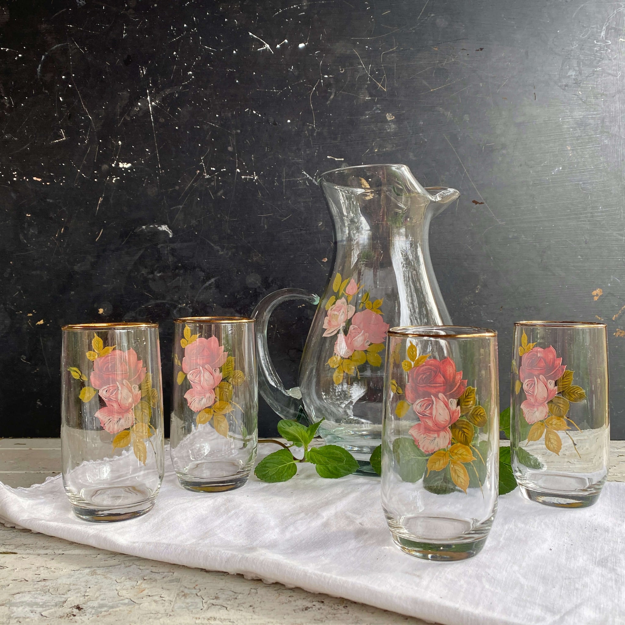 https://shopinthevintagekitchen.com/cdn/shop/products/vintage-glass-pitcher-set-with-red-pink-roses_1_2048x2048.jpg?v=1680910056
